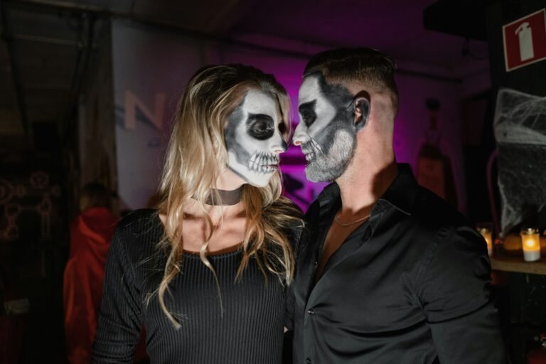 man in black dress shirt beside woman in white mask